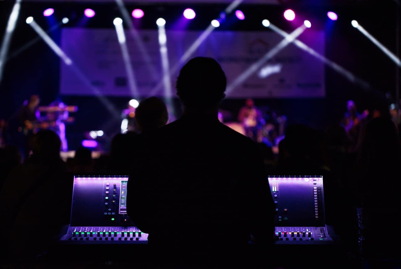 An Audio Visual Technical director standing behind the producer desk at a live event for live event consulting and live event planning for PAV Designs